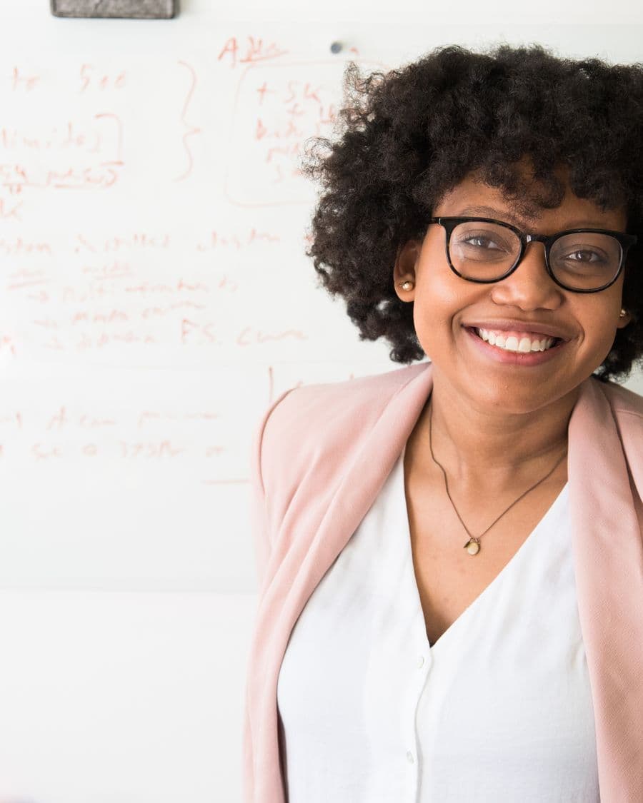 Black woman with a warm, professional smile in an office setting